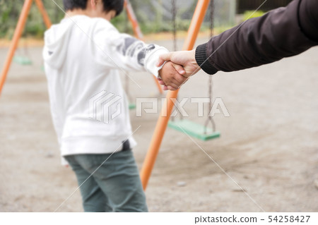 Man pulling dad's hand in park, dad abuse Man pulling dad's hand in park, dad abuse 54258427