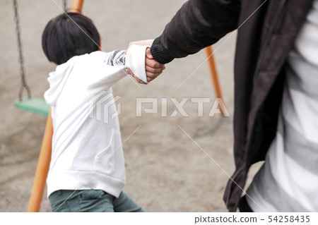 Man pulling dad's hand in park, dad abuse 54258435