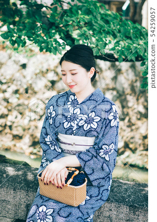 A woman in a yukata resting in the shade of a tree A woman in a yukata resting in the shade of a tree 54259057