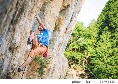 Man climbs rock. 54263430