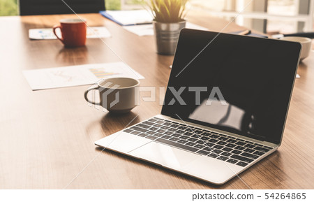 Laptop computer on the table in meeting room. 54264865