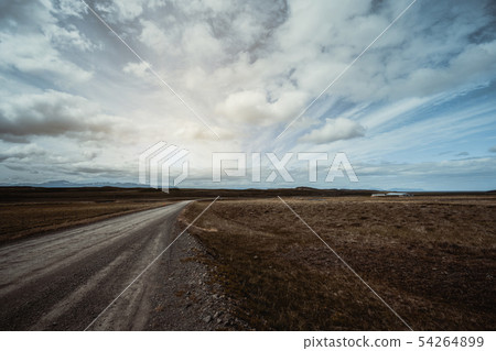 Empty dirt road through countryside landscape. Empty dirt road through countryside landscape. 54264899