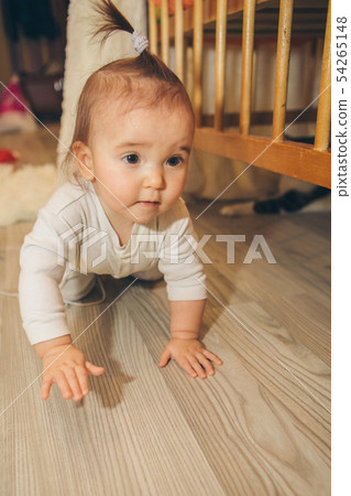 little girl with tail on head crawling on floor little girl with tail on head crawling on floor 54265148