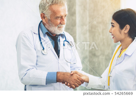 Senior male doctor working with another doctor. Senior male doctor working with another doctor. 54265669