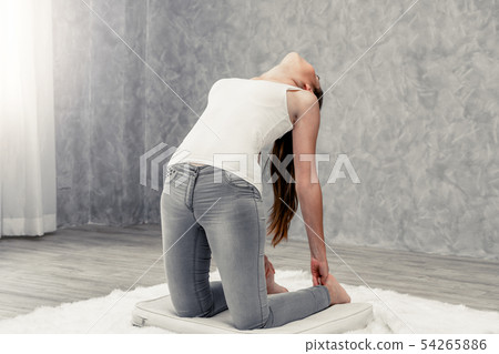 Young woman yoga on carpet at home living room. 54265886