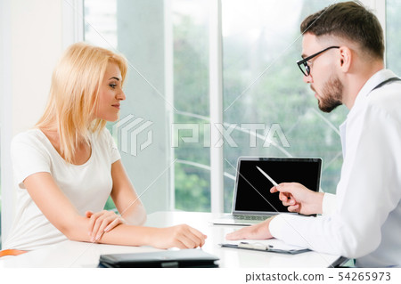 Male Doctor and Female Patient in Hospital Office 54265973