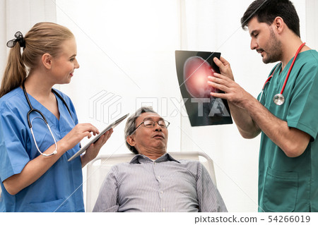 Doctor team work with x ray film image of patient. Doctor team work with x ray film image of patient. 54266019