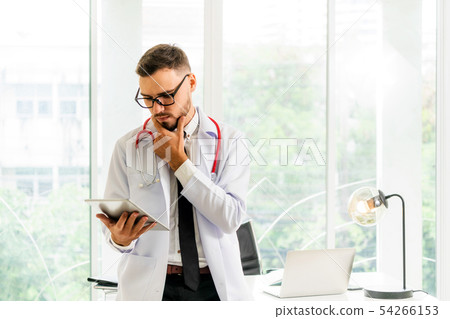 Doctor working on tablet computer in the hospital. Doctor working on tablet computer in the hospital. 54266153