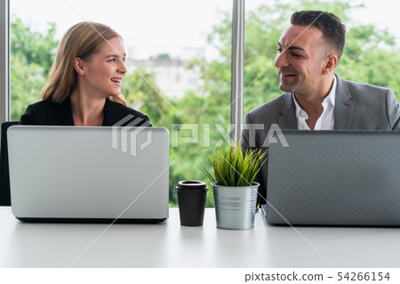 Businessman and businesswoman working in office. Businessman and businesswoman working in office. 54266154