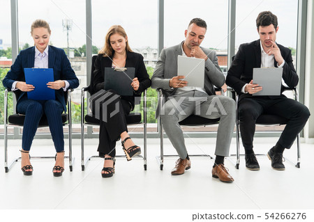 Businesswomen and businessmen wait for interview. Businesswomen and businessmen wait for interview. 54266276