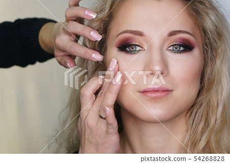 Make up artist working in make up studio, applying Make up artist working in make up studio, applying 54268828