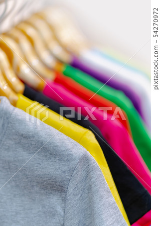Close up of Colorful t-shirts on hangers Close up of Colorful t-shirts on hangers 54270972