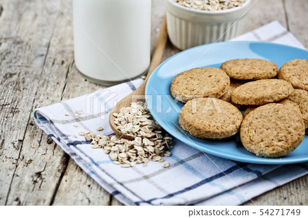 Fresh baked oat cookies on blue ceramic plate on Fresh baked oat cookies on blue ceramic plate on 54271749