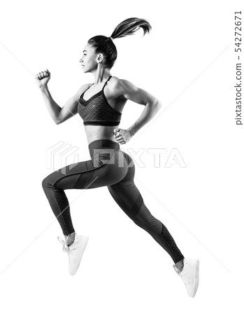 Young woman runner in blue sportswear jump in the air. 54272671