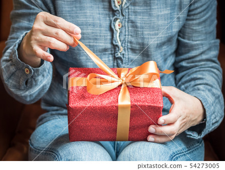 Hands holding opening gift boxes gold ribbon Hands holding opening gift boxes gold ribbon 54273005
