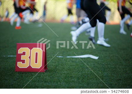 Image of soccer field with number thirty running football players on blurred background Image of soccer field with number thirty running football players on blurred background 54274608