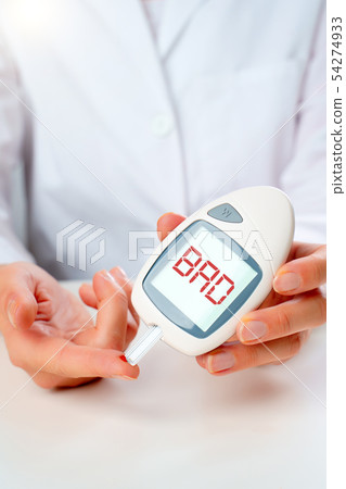 Photo of hand man with glucometer with bro inscription in studio 54274933