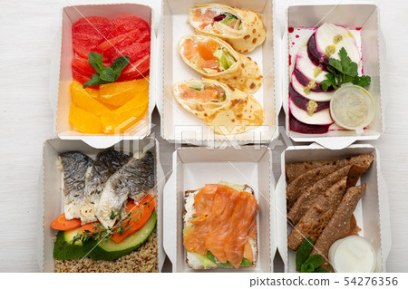 Set of healthy meals for the day in lunch boxes stands on a white table. Concept of menu of proper Set of healthy meals for the day in lunch boxes stands on a white table. Concept of menu of proper 54276356
