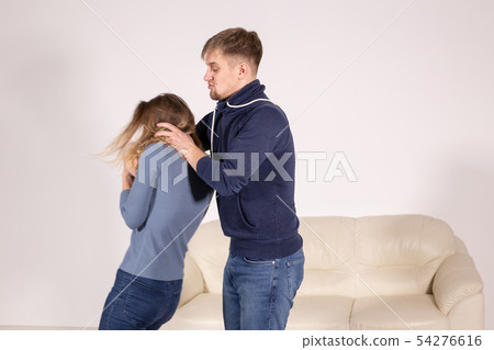 People, abuse and violence concept - aggressive man strangling his wife People, abuse and violence concept - aggressive man strangling his wife 54276616