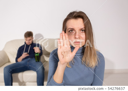 Alcoholism, abuse and problem concept - Sad woman shows stop sign, stop domestic violence 54276637