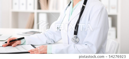 Doctor woman sitting at the desk with computer at workplace in hospital office. Unknown physician's 54276923