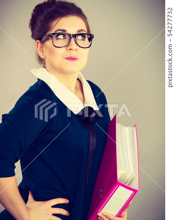 Happy positive business woman holding binder with 54277732