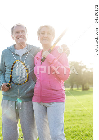 Senior couple with hiking poles walking 54280172