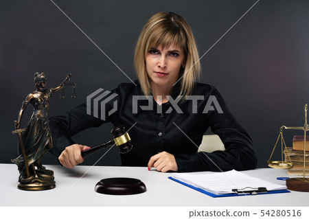 A young fair woman judge works in her office. 54280516