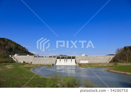 Spring's Tobetsu dam in a large flood of water 54280758