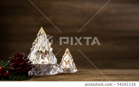 Modern glass Christmas tree with lights on dark Modern glass Christmas tree with lights on dark 54281138