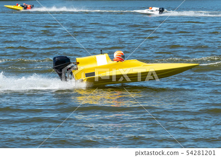 Yellow speed boat in race Yellow speed boat in race 54281201