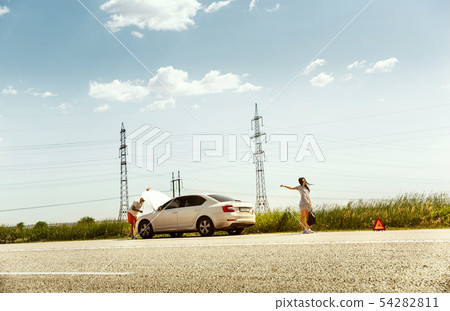 Young couple traveling on the car in sunny day Young couple traveling on the car in sunny day 54282811