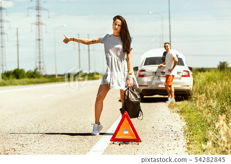 Young couple traveling on the car in sunny day 54282845