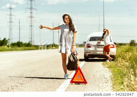 Young couple traveling on the car in sunny day Young couple traveling on the car in sunny day 54282847