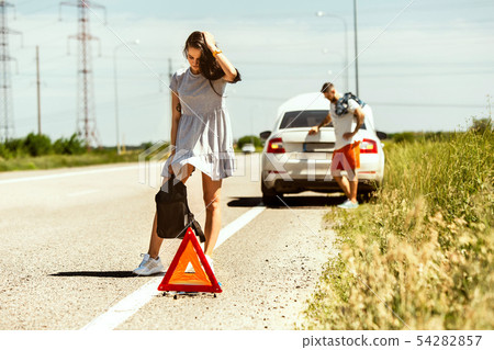 Young couple traveling on the car in sunny day 54282857