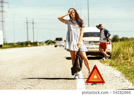 Young couple traveling on the car in sunny day 54282860