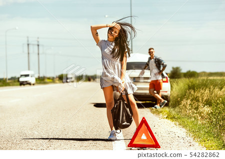 Young couple traveling on the car in sunny day Young couple traveling on the car in sunny day 54282862