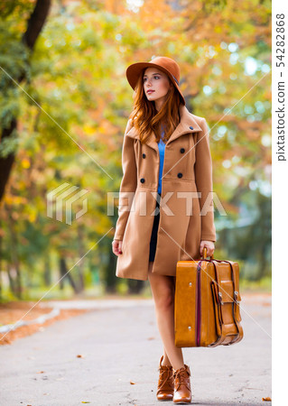 beautiful young woman with suitcase on the wonderful autumn park background beautiful young woman with suitcase on the wonderful autumn park background 54282868