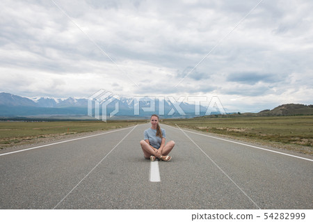 Woman sitting on the road 54282999
