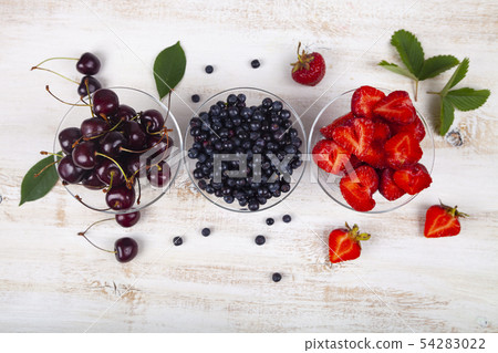 Ripe berries in transparent bowls Ripe berries in transparent bowls 54283022