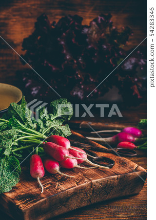 Red radish on cutting board Red radish on cutting board 54283346