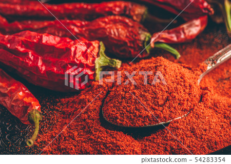 Spoonful of ground red chili pepper 54283354