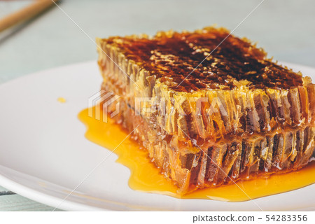 Sweet honeycomb on light background Sweet honeycomb on light background 54283356