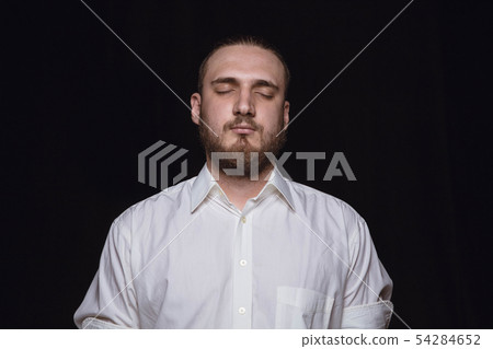 Close up portrait of young man isolated on black studio background 54284652