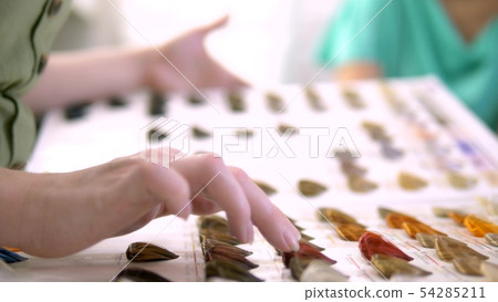 Color palette and selection of hair color. woman chooses a hair dye color 54285211