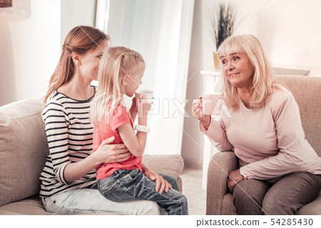 Beautiful long-haired woman having a warm talk with her mother Beautiful long-haired woman having a warm talk with her mother 54285430