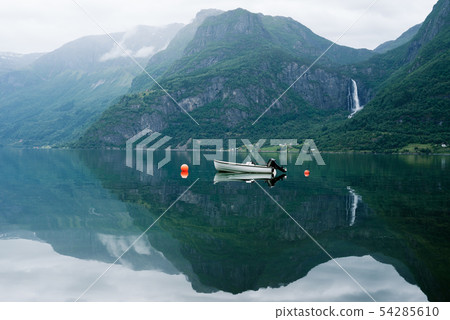 Landscape with a boat in the fjord and a waterfall 54285610