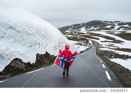 Girl with a Norwegian flag on a mountain road in Girl with a Norwegian flag on a mountain road in 54285617