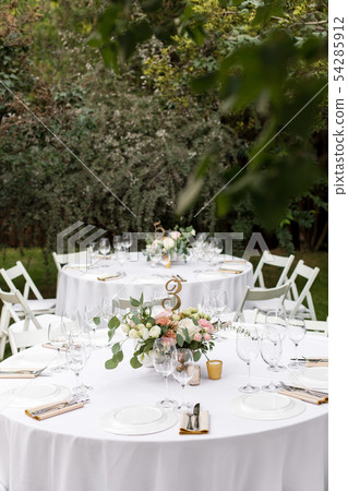 Wedding table setting decorated with fresh flowers 54285912