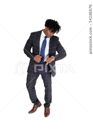 Relaxed black man standing in a suit looking at Relaxed black man standing in a suit looking at 54286876